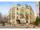 Exterior of a contemporary yellow building featuring multiple balconies and street access at 340 S Lafayette St # 201, Denver, CO 80209