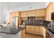 Modern kitchen with stainless steel appliances, wooden cabinets and view into the living space at 340 S Lafayette St # 201, Denver, CO 80209