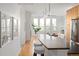 Bright kitchen with a counter and island, modern lighting, with hardwood floors and view to living room at 340 S Lafayette St # 201, Denver, CO 80209