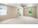 A spacious bedroom with three windows allowing for natural light and a ceiling fan for added comfort at 19029 E 58Th Ave, Denver, CO 80249