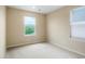 Bright bedroom features two windows that let in natural light and neutral carpet and paint at 19029 E 58Th Ave, Denver, CO 80249