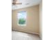 Bright bedroom features one large window that let in natural light and neutral carpet and paint at 19029 E 58Th Ave, Denver, CO 80249