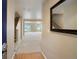 Bright foyer with wood floors, carpeted stairs, and neutral walls leading to a spacious living area at 19029 E 58Th Ave, Denver, CO 80249