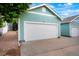 Detached two car garage with teal painted siding and white door, plus adjacent driveway parking at 19029 E 58Th Ave, Denver, CO 80249