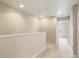 Bright hallway with neutral carpet and paint, leading to bedrooms, creating a welcoming and cohesive transition space at 19029 E 58Th Ave, Denver, CO 80249