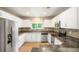 Modern kitchen featuring white cabinets, stainless steel appliances, and mosaic tile backsplash at 19029 E 58Th Ave, Denver, CO 80249
