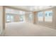 Spacious living room with neutral carpet, ample natural light, and access to the backyard at 19029 E 58Th Ave, Denver, CO 80249