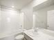 Clean bathroom with a white tiled shower-tub combination, gray vanity, white countertop, and large mirror at 379 Remuda Rd, Berthoud, CO 80513