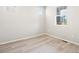 Bright bedroom with wood look floors, white walls, and multiple windows at 379 Remuda Rd, Berthoud, CO 80513