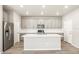 Kitchen features stainless steel appliances, island with sink, and gray cabinets at 379 Remuda Rd, Berthoud, CO 80513