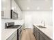 Modern kitchen design with stainless steel appliances, gray cabinets, and white quartz countertops at 379 Remuda Rd, Berthoud, CO 80513