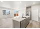 Open concept kitchen with stainless steel appliances, an island with seating, and access to the outdoor deck at 379 Remuda Rd, Berthoud, CO 80513