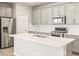 Modern kitchen features stainless steel appliances, white subway tile, and gray cabinets at 379 Remuda Rd, Berthoud, CO 80513
