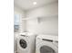 Bright laundry room with large window and white front loading washer and dryer at 379 Remuda Rd, Berthoud, CO 80513