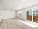 Open living room with recessed lighting, wood look floors, and sliding glass doors at 379 Remuda Rd, Berthoud, CO 80513