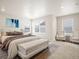 Spacious primary bedroom with hardwood floors, sitting area, and bright windows, perfect for relaxation at 379 Remuda Rd, Berthoud, CO 80513