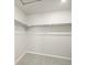 Empty walk-in closet with neutral carpet and white shelving, providing ample storage and organization options at 379 Remuda Rd, Berthoud, CO 80513
