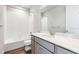 Bathroom featuring tile surround tub with shower, sink and vanity with storage at 1699 Morgan Dr, Erie, CO 80516