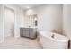 Primary bathroom featuring a soaking tub, and double vanity at 1699 Morgan Dr, Erie, CO 80516