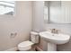 Powder room featuring a pedestal sink and neutral color palette at 1699 Morgan Dr, Erie, CO 80516