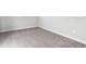 Neutral bedroom featuring gray carpet, white trim and baseboards, with wall outlets at 1699 Morgan Dr, Erie, CO 80516