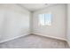 Bedroom featuring neutral carpet, white trim, and a window with outside views at 1699 Morgan Dr, Erie, CO 80516