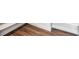 Close up of elegant wood flooring with white baseboards and trim at 1699 Morgan Dr, Erie, CO 80516