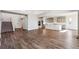 Open-concept great room with hardwood floors flows to a gourmet kitchen and modern staircase at 1699 Morgan Dr, Erie, CO 80516