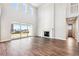 Sun-filled living room boasts hardwood flooring, a cozy fireplace, and large windows at 1699 Morgan Dr, Erie, CO 80516