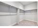 Spacious walk-in closet with ample storage and carpeted floors at 1699 Morgan Dr, Erie, CO 80516