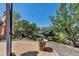 Beautifully landscaped backyard features mature trees, an umbrella-covered patio, and well-manicured plants at 6345 S Ider Way, Aurora, CO 80016
