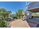 Landscaped backyard features a tiled patio, seating area, and stairs leading to an upper level at 6345 S Ider Way, Aurora, CO 80016