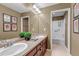 Bathroom with double sink vanity, large mirror, and separate tub/shower area at 6345 S Ider Way, Aurora, CO 80016