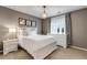 Well-lit bedroom featuring white furniture, neutral walls, sheer curtains, and decorative chandelier at 6345 S Ider Way, Aurora, CO 80016
