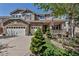 Charming two-story home featuring stone accents, three-car garage, a front porch and a well-manicured lawn at 6345 S Ider Way, Aurora, CO 80016
