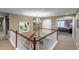 Bright foyer with stairway and artwork, leading to a bedroom area with decorative chandelier at 6345 S Ider Way, Aurora, CO 80016
