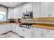 Modern kitchen featuring white cabinets, stainless steel appliances, and stone countertops at 6345 S Ider Way, Aurora, CO 80016