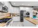 Spacious kitchen with white cabinets, stainless steel appliances, and a center island at 6345 S Ider Way, Aurora, CO 80016
