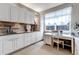 Bright laundry room with ample counter space, cabinets, and a dedicated sewing area at 6345 S Ider Way, Aurora, CO 80016