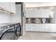 Well-organized laundry room with modern washer and dryer and plenty of cabinet space at 6345 S Ider Way, Aurora, CO 80016