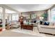 Bright living room with neutral decor, plush seating, and an open layout at 6345 S Ider Way, Aurora, CO 80016
