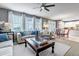 Open-concept living room and dining area filled with natural light, stylish decor, and comfortable seating at 6345 S Ider Way, Aurora, CO 80016