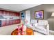Living space with comfortable furniture and a wet bar with dark wood cabinetry at 6345 S Ider Way, Aurora, CO 80016