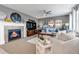 Comfortable living room featuring a fireplace, a ceiling fan, and neutral colors at 6345 S Ider Way, Aurora, CO 80016