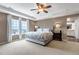 Serene main bedroom with large windows offering picturesque views and elegant ensuite at 6345 S Ider Way, Aurora, CO 80016