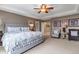 Spacious main bedroom with neutral paint, a ceiling fan, tray ceiling and ample natural light at 6345 S Ider Way, Aurora, CO 80016