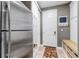 Functional mud room features stainless steel refrigerator, closet, and storage bench at 6345 S Ider Way, Aurora, CO 80016