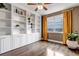 Bright home office featuring built-in bookshelves and large windows with neighborhood views at 6345 S Ider Way, Aurora, CO 80016