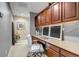Functional home office with built-in desk, ample cabinet space, and a comfortable white chair at 6345 S Ider Way, Aurora, CO 80016