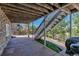 Covered patio features stone accents, concrete flooring, and stairs leading to a landscaped backyard at 6345 S Ider Way, Aurora, CO 80016